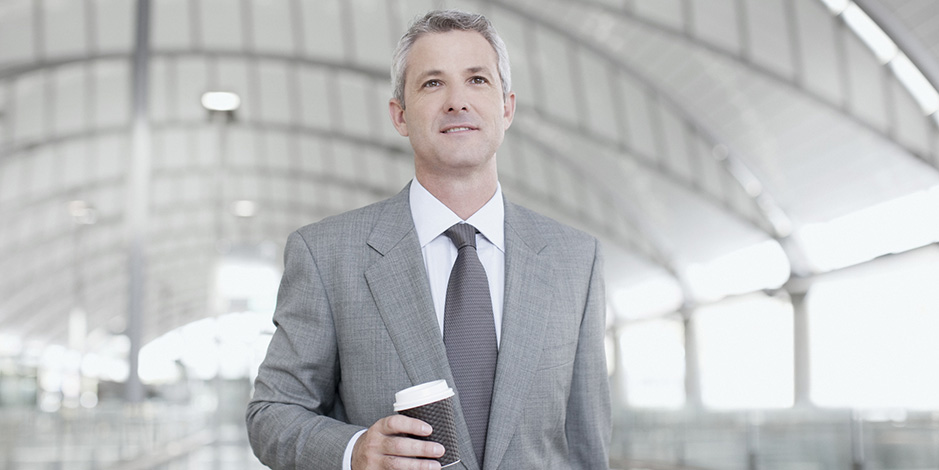 businessman walking holding coffee